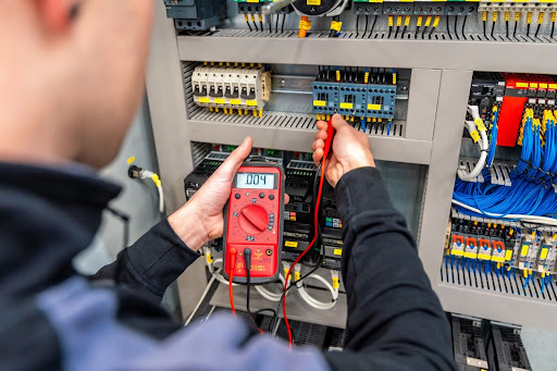 Closeup of a worker repairing an electrical system panel