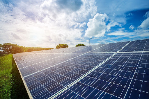 solar panels with sunset in background